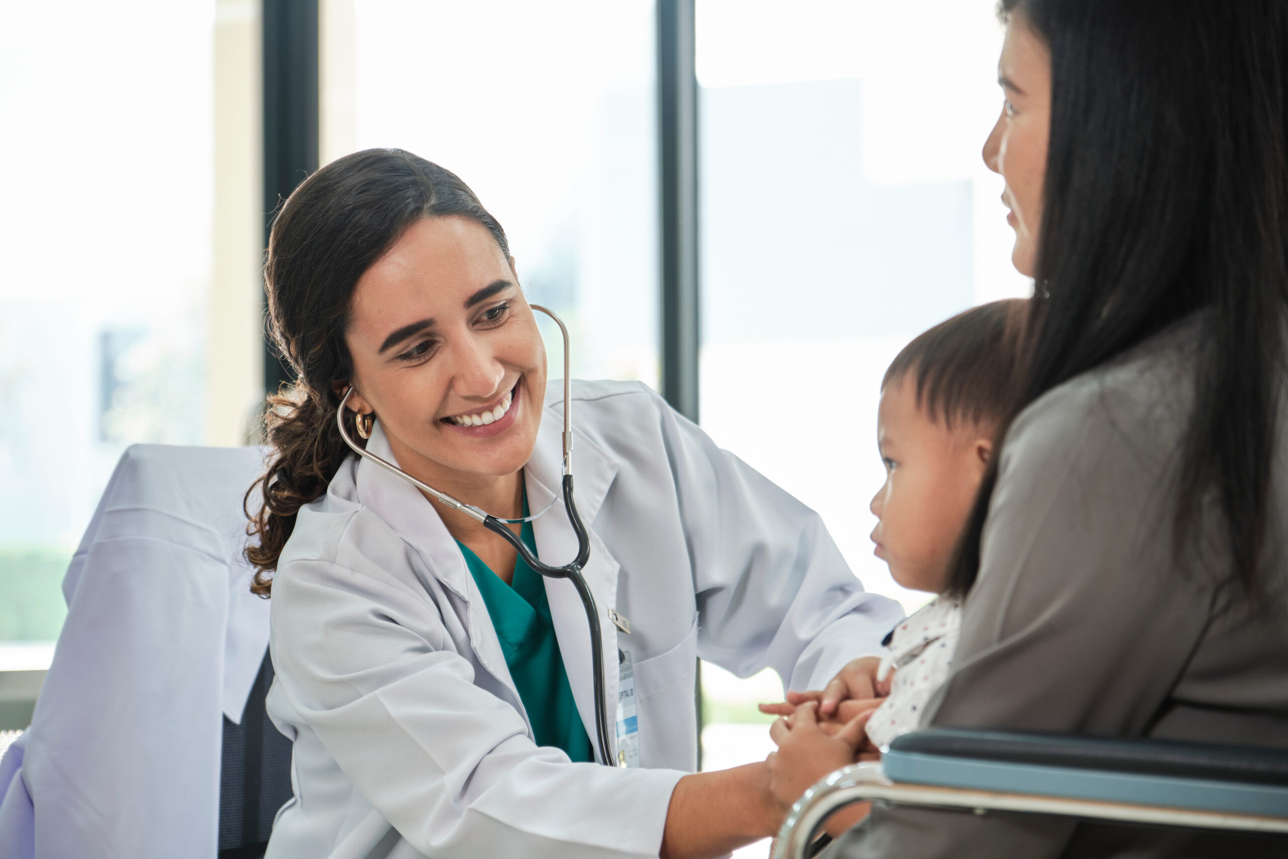 Female doctor teases boy before examination.